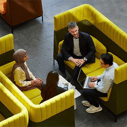 A group of Qantas employees sitting in 'The Street' of the head office in Mascot