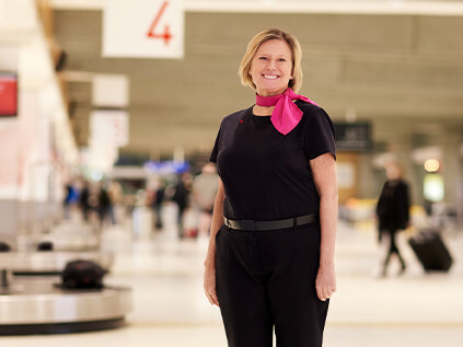 A baggage service employee at the luggage carousel