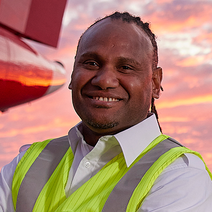 An aircraft maintenance engineer smiling at the camera