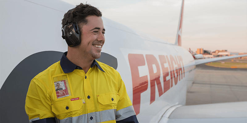 A Qantas Freight employee outside a Freight aircraft 