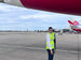 A Qantas Graduate at the hangar in front of a plane