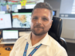 Qantas meteorologist, smiling at camera with weather images on screen