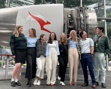 Qantas interns next to a jet engine in Mascot, Sydney