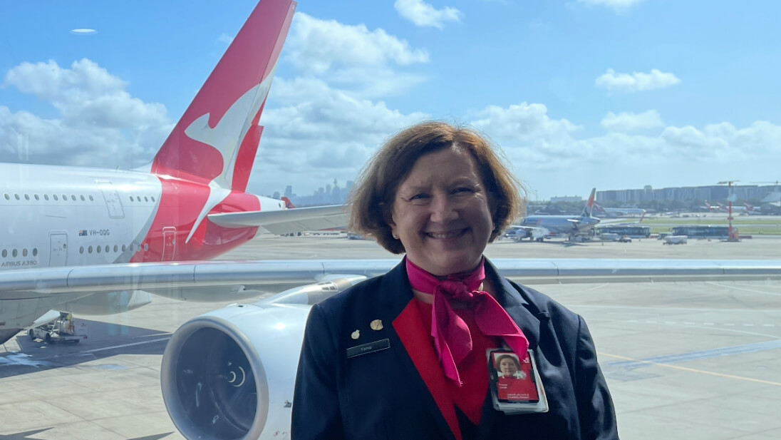 Airport Customer Service Agent smiling in front of aircraft