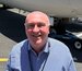 Engineering Manger smiling on tarmac