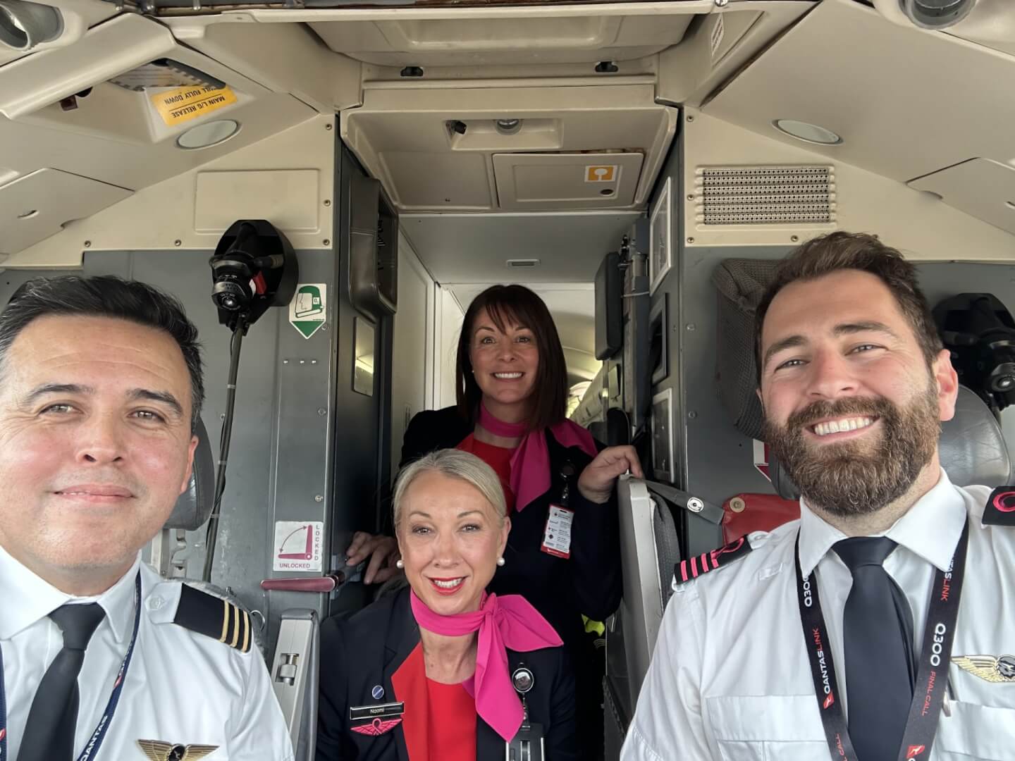 flight crew smiling as they leave the terminal