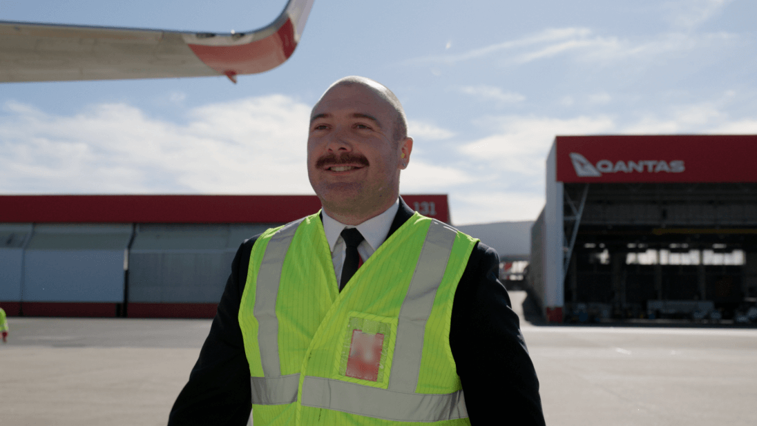 flight crew smiling as they leave the terminal
