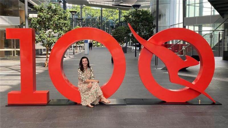 Qantas employee smiling at the camera in the Qantas headquarters