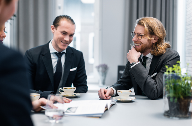 two colleagues having a conversation in a glass room