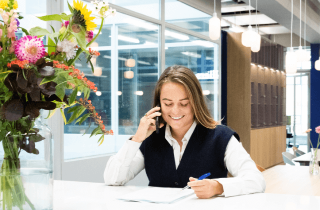 two colleagues having a conversation in a glass room