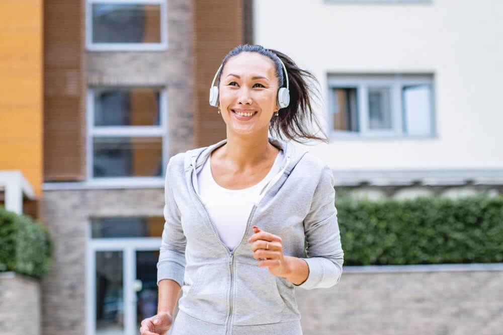 image of a lady running with headphones
