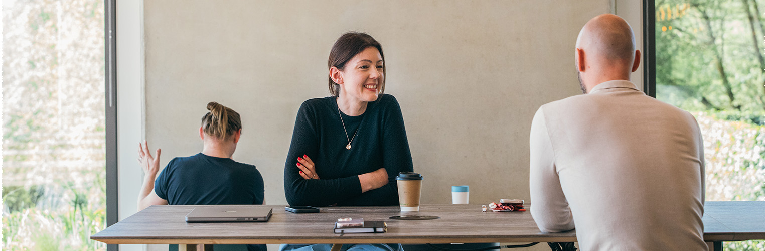 Image of two people talking 