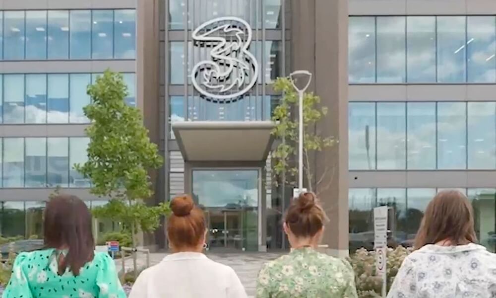 Image of three people walking into the Reading office