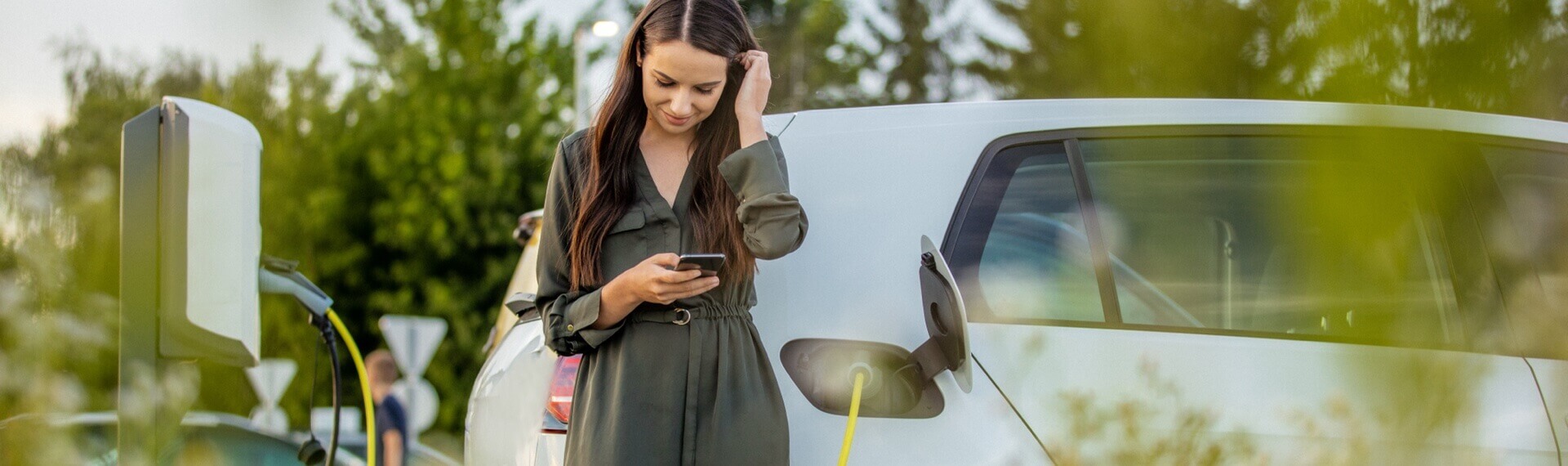 Lady charging her electric car