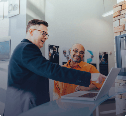 An image of two colleagues looking at a computer