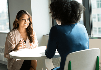 An image of two women speaking 