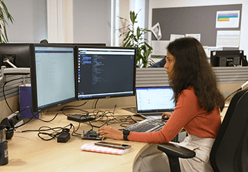 An image of a woman sitting at a computer