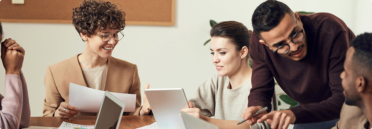 An image of two people looking at a computer