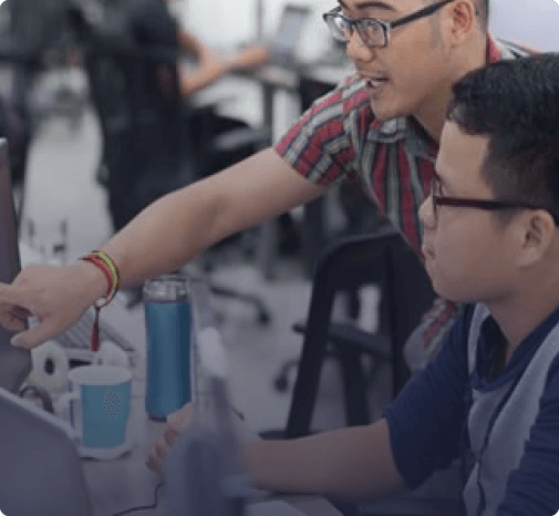 An image of two colleagues looking at a computer