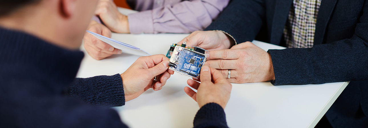 People holding a circuit board