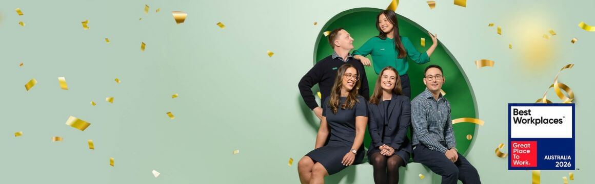 A group of specsavers employees surrounded by confetti with the best workplaces badge