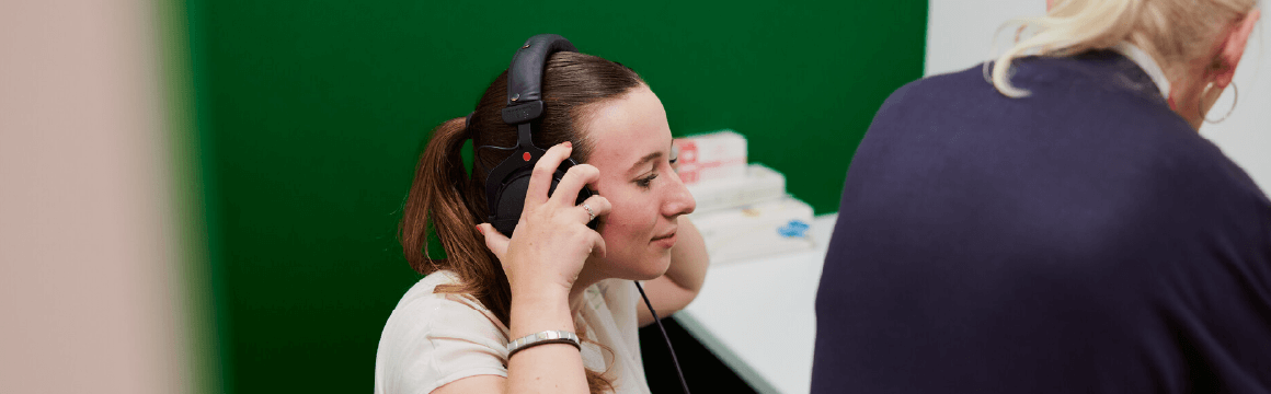 Lady with headphones on getting hearing test