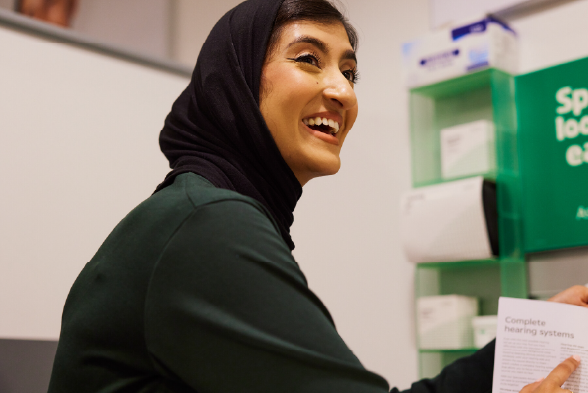 Person working in Specsavers audiology test room