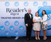 Picture of a man, and two women accepting an award