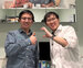 Two men stand in a optometry test room