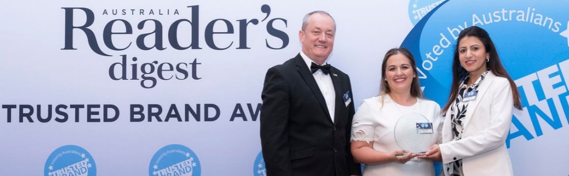 Picture of a man, and two women accepting an award