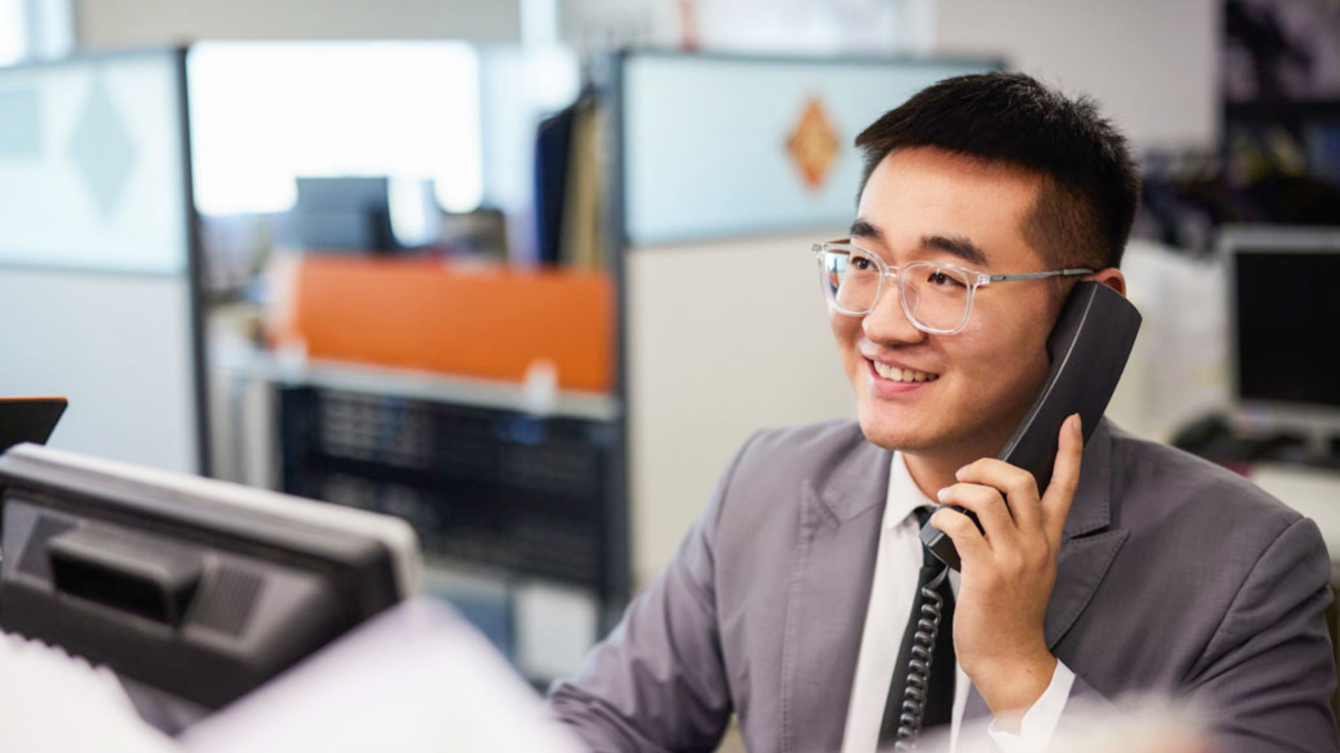 sales person on phone smiling 