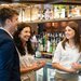 Four front of house Heartists having a fun conversation by the bar in the hotel.