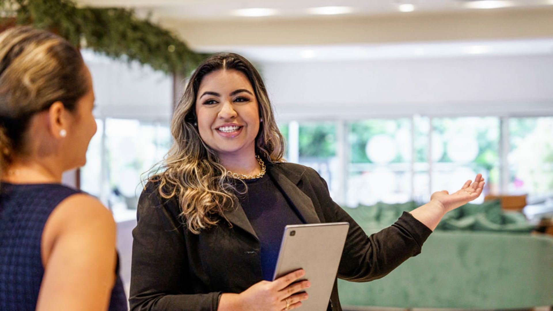 food and beverage manager at accor smiling holding ipad and giving directions 