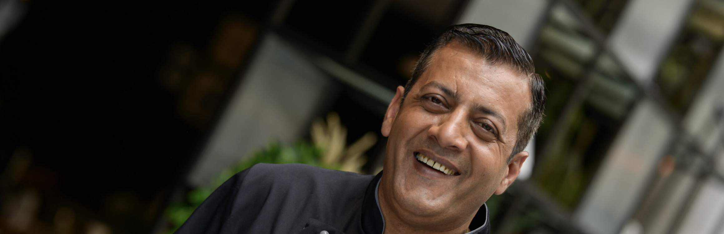 manvir singh-  executive chef smiling with hand on heart 