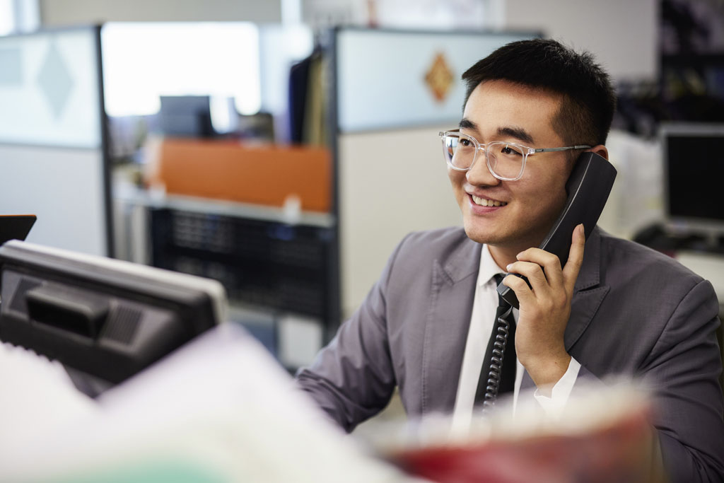 sales person on phone smiling 