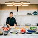 a chef prepping a breakfast spread 