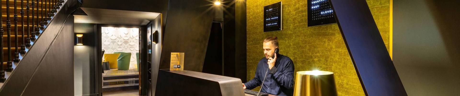 A man behind a hotel reception desk