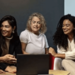 head office job at accor - people sitting around a table smiling with a laptop 