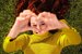 woman making heart shape with her hands and smiling