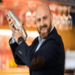 andrea di coppi - shaking up a drink in a shaker and smiling in a suit