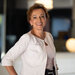 kristina - hotel general manager at Accor posing for a photo and smiling in white suit