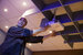 maintenance technician fixing a projector 