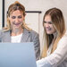 image of receptionists sitting at computer smiling 