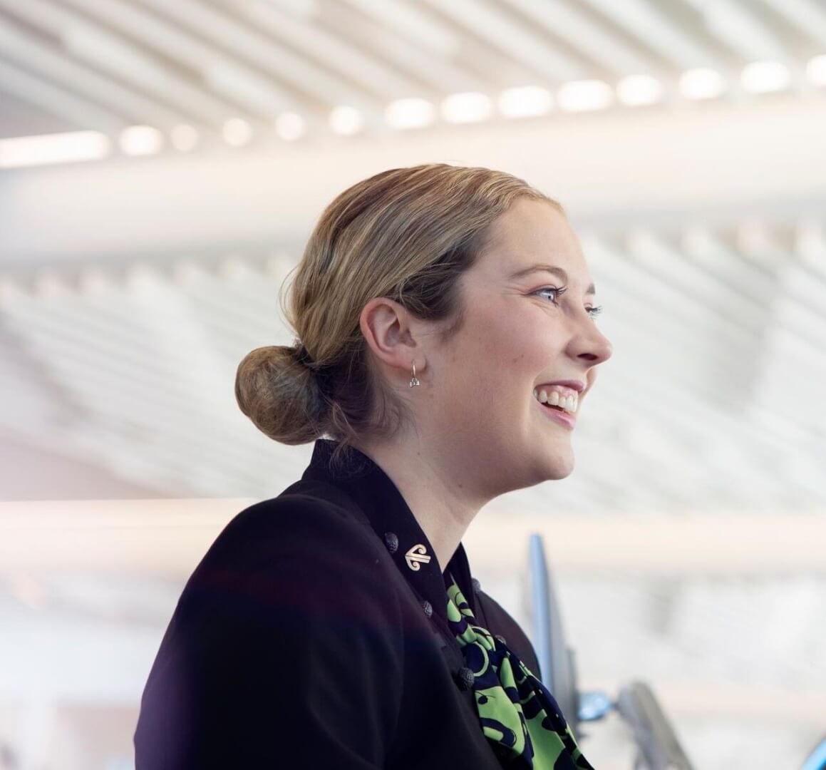  a member of the cargo crew smiling on the tarmac