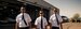 3 pilot cadets walking by hangar