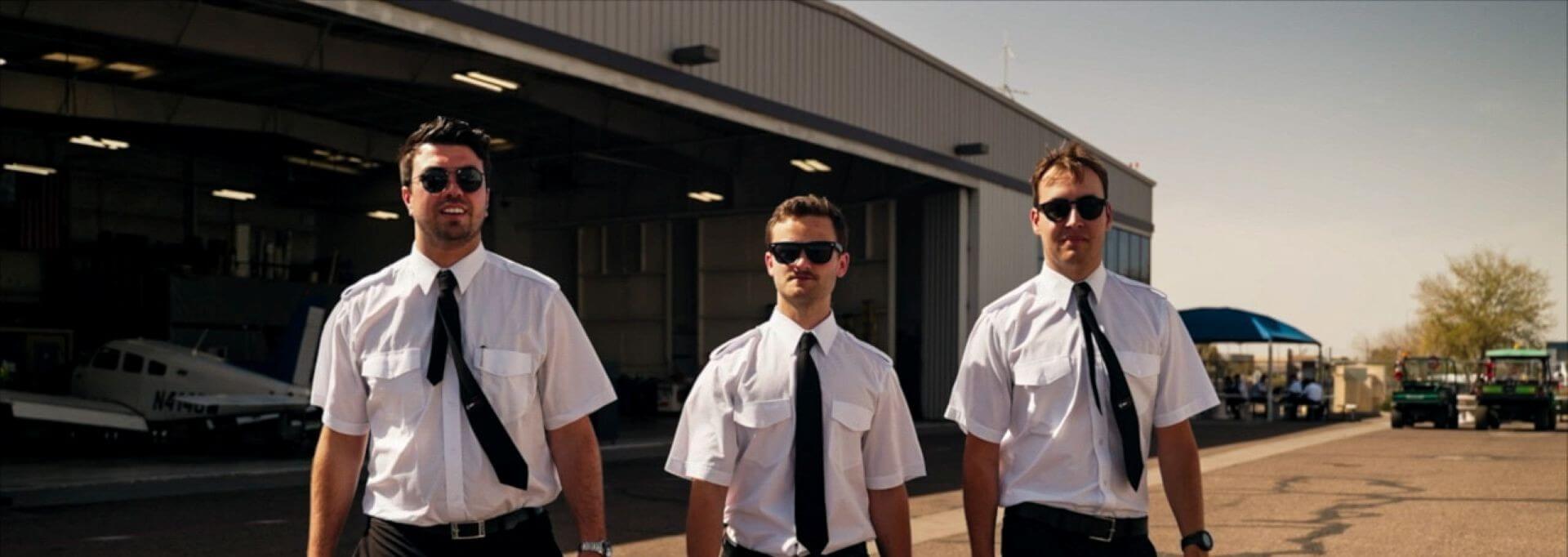 3 pilot cadets walking by hangar
