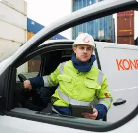 a man in high vis and a helment getting out of a white Koncranes branded van