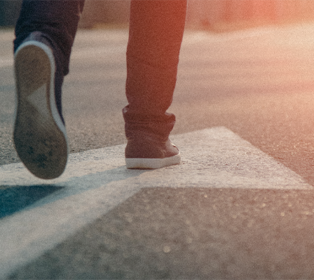 women sitting on a bed using a laptop