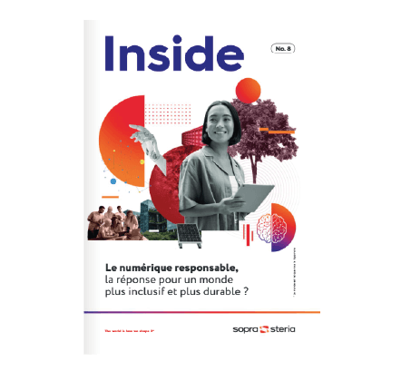 women sitting on a bed using a laptop