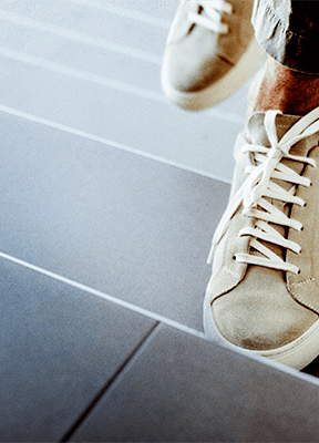 women sitting on a bed using a laptop